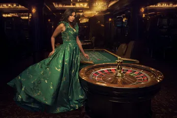 A man celebrating a winning moment on his laptop while gaming symbols float around him, capturing the excitement of JILI696 games.