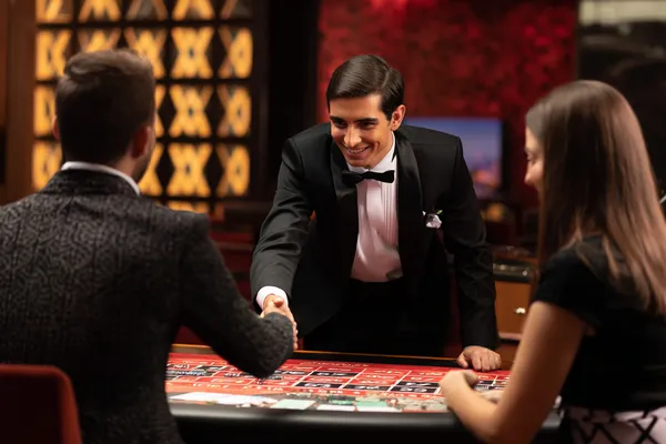 JILI696 — A high-class gaming experience without limits A woman in a luxurious green gown next to an ornate roulette wheel, capturing the upscale casino mood of JILI696.